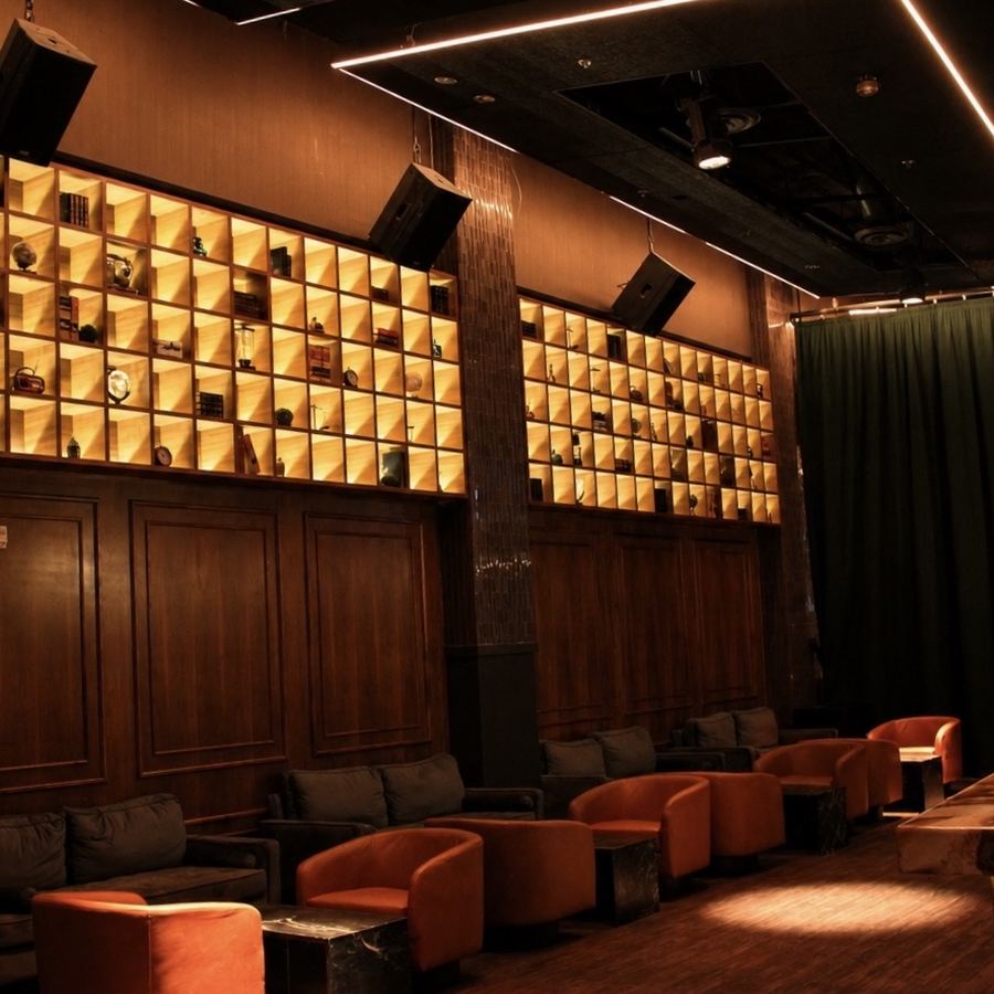 Lounge seating beneath the illuminated card-catalog wall at Archive Sacramento